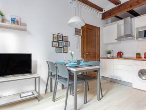 a kitchen and dining room with a table and chairs at UNIK. Apartments Valencia in Valencia +7 photos
