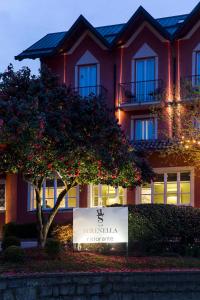 a building with a sign in front of it at Hotel Serenella in Baveno