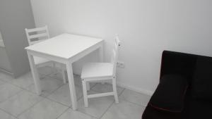 ポズナンにあるApartament Matejkiの白いテーブルと椅子