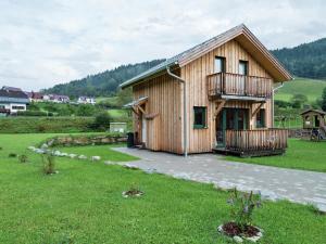 a wooden house with a balcony and a yard at Stolz in Murau