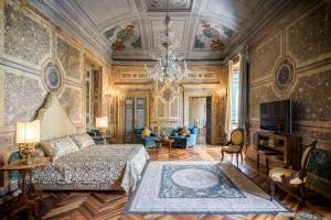 a bedroom with a bed and a chandelier at Residenza Ruspoli Bonaparte in Rome