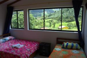 a bedroom with a bed and a large window at Hotel Internacional Jardín in Jardin