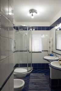 a bathroom with a shower and a toilet and a sink at Casa Miranda in Vico Equense