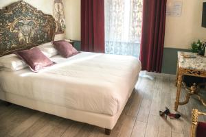 Postel nebo postele na pokoji v ubytování Ripetta Rooms