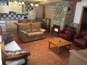a living room with couches and a fire place at La Antigua Vaquería in Cuenca