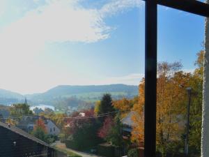 a view from the living room window of the fall foliage at Quaint Apartment in Vielsalm with Private Terrace in Vielsalm