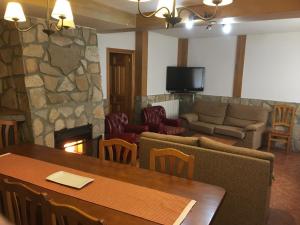 a living room with a table and a fireplace at La Antigua Vaquería in Cuenca