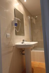 a bathroom with a sink and a shower at Residencial Super Stop Palafrugell in Palafrugell