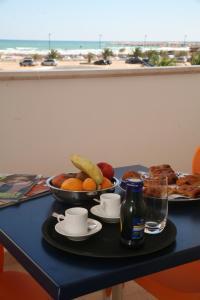 a table with a plate of food and a bowl of fruit at Hotel Yria in Vieste