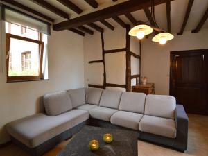 a living room with a couch and a table at Spacious holiday home in Teuven with garden in Teuven