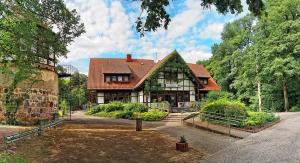 a large house with a roof at Neue Mühle Kleines Landhotel in Brandenburg an der Havel