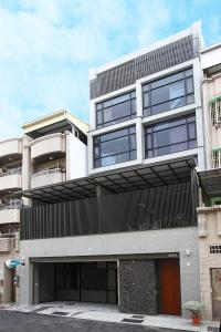a large white building with a lot of windows at Jack Castle in Tainan