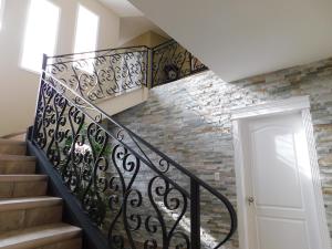 a staircase with wrought iron railings and a brick wall at Lakeshore Inn in Cold Lake