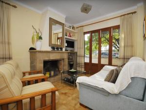 a living room with a couch and a fireplace at Belvilla by OYO Cora in Port d'Alcudia