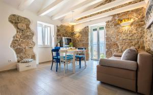 a living room with a couch and a table at Apartman Bonaca in Vrbnik