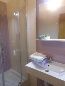 a bathroom with a shower and a sink with a shower at Donami Apartments in Pag