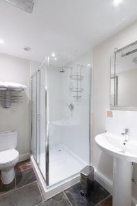 a bathroom with a shower and a toilet and a sink at The Old Vine in Winchester