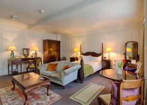 a bedroom with a bed and a couch and a table at The Old Vine in Winchester