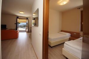 a small room with two beds and a hallway at Casa Vacanze Sole in Tremosine Sul Garda +21 photos