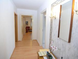 a hallway of a apartment with a table and a mirror at Wohnung nahe dem Skigebiet in Wehrstapel in Meschede +32 photos