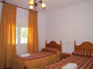 Postel nebo postele na pokoji v ubytování Apartamentos Rurales El Pinar + 30 fotografií