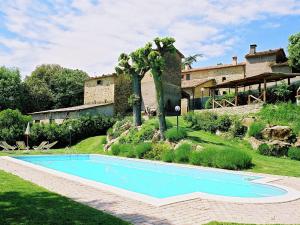 a swimming pool in front of a house at Stunning Holiday Home in Umbria With Jacuzzi in Monte Santa Maria Tiberina