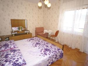 a bedroom with a bed and a dresser and a mirror at Neat apartment in Vinisce with magnificent sea and beach within walking distance in Vinišće