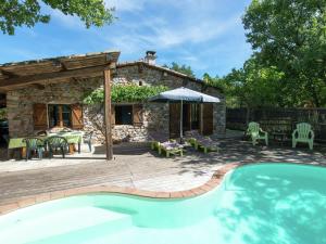 a patio with a swimming pool and a house at Nice holiday home with pool in Ard che in Saint Alban Auriolles