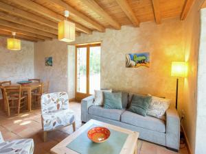 a living room with a couch and a table at Nice holiday home with pool in Ard che in Saint Alban Auriolles