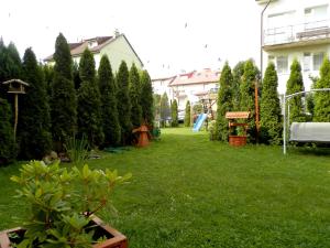 a yard with a bunch of trees and a playground at Dom Wczasowy Olivia in Ustka