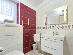 a white bathroom with a sink and a mirror at Villa Rose in Kršan +14 photos