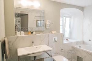 a bathroom with a sink, toilet and bathtub at Palazzo Radomiri Heritage Boutique Hotel in Kotor