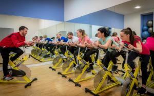 a group of people on exercise bikes in a gym at Maldron Hotel Shandon Cork City in Cork