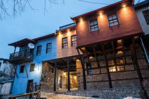 an exterior view of a building with lights on at Olganos VL Luxury Rooms & Suites in Veria