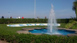 a fountain in a park with people standing around it at Casa Domenica - 200m dal mare in Ceriale