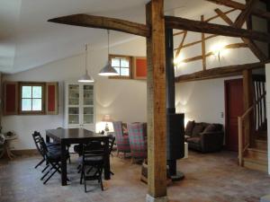 een keuken en eetkamer met een tafel en een open haard bij Superb villa with private heated pool in Revigny-sur-Ornain