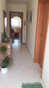 a room with a hallway with a living room at Apartments Feniks in Pag