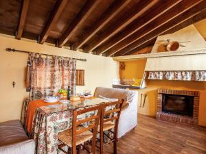a living room with a table and a fireplace at Vintage Farmhouse in Algarinejo with Terrace in Fuentes de Cesna