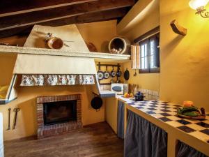 a kitchen with a checkered floor and a fireplace at Vintage Farmhouse in Algarinejo with Terrace in Fuentes de Cesna