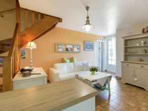 a living room with a white couch and a table at Relaxing g te with terrace near Pont Aven in Mellac