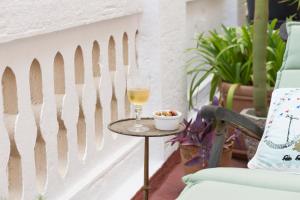 a glass of wine on a table next to a fence at The Patio Barcelona in Barcelona
