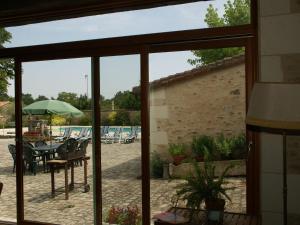 a view of a patio with a table and chairs at Beautiful holiday home with private pool in Boussageau