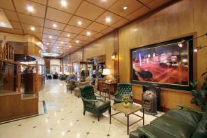 a lobby with a large flat screen tv on the wall at Gran Hotel De La Paix in Buenos Aires