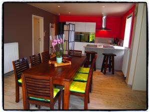 a kitchen and dining room with a wooden table and chairs at Comfy holiday home with terrace in Ellezelles in Ellezelles