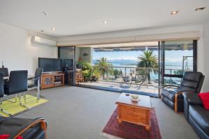 a living room with a view of the ocean at Waterfront Escape in Nelson