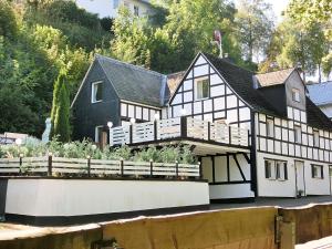 a black and white house with a garden in front of it at Stylish holiday home near a ski resort in Schmallenberg