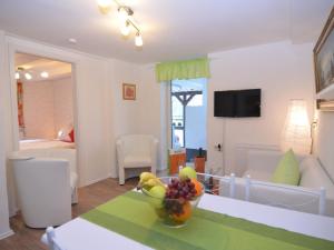 a living room with a bowl of fruit on a table at Stylish holiday home near a ski resort in Schmallenberg