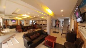 a large living room with a couch and a tv at Libertad Hotel in Trujillo