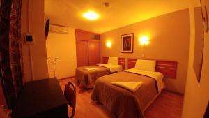 Postel nebo postele na pokoji v ubytování Libertad Hotel