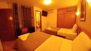 Postel nebo postele na pokoji v ubytování Libertad Hotel